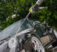 Person washing a black car with a  Active™ Premium Pressure Washer 20° Lance