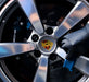 Close-up of a Porsche car wheel with the brand logo.