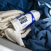 Bottle of GYEON towel wash surrounded by folded towels in a basket