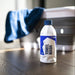 Bottle of Gyeon towel wash on a wooden floor with a blue towel in the background