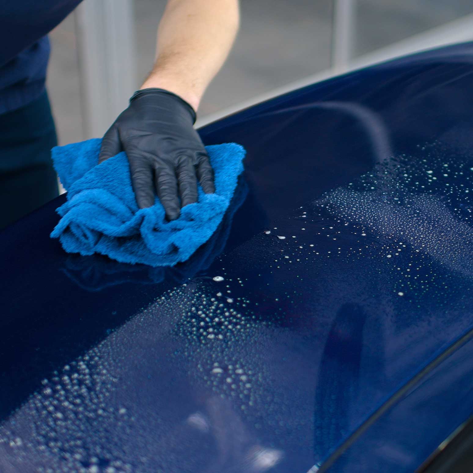 Person wiping away the Gyeon WaterSpot Remover residue