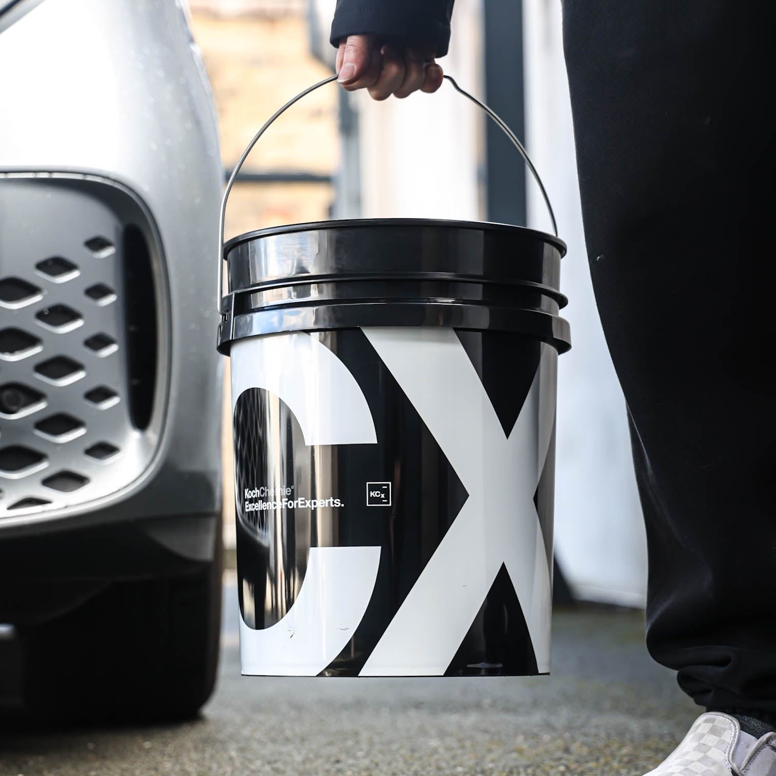 Polished Bliss Koch Chemie 20L detailing bucket with large black and white CX logo, black lid, and metal handle.