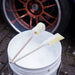 Two Sponge Guru Oval Wheel Brushes on a white bucket with a car wheel in the background