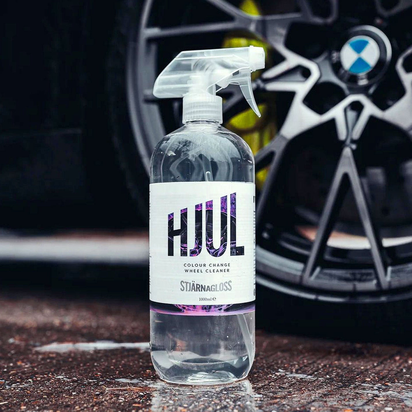 Bottle of Stjarnagloss Hjulwheel cleaner in front of a car wheel