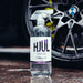 Bottle of Stjarnagloss Hjulwheel cleaner in front of a car wheel