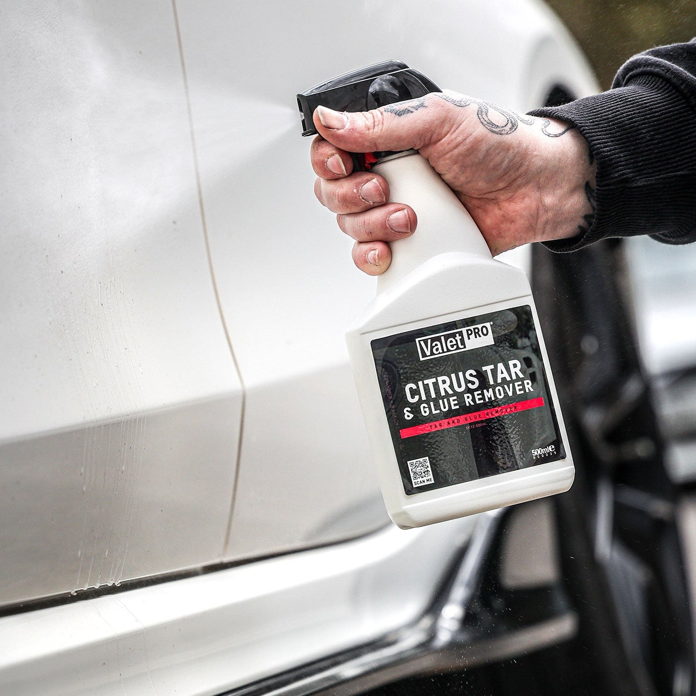Person using Valet Pro Citrus Tar & Glue Remover on a car.